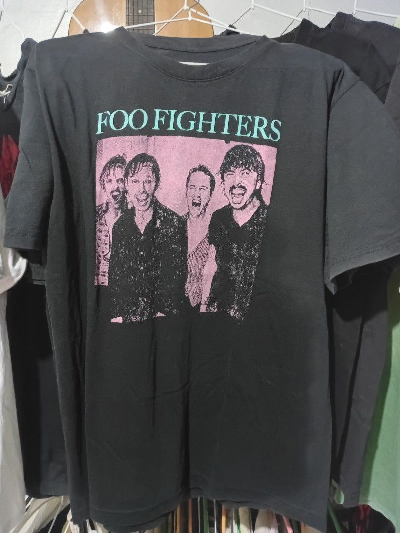 Foo Fighters Band T-Shirt (Category: Tshirts & Polo Shirts ) located in Quezon City. Submitted by reddcluttermnl (Listing ID 1431886372, Image 1). Description: - Foo Fighters band t-shirt - Long-sleeved style - Black shirt with pink and black graphic - Graphic features band members - Folded.