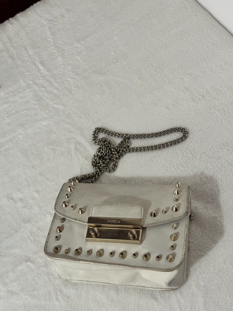 Furla Julia Studded Metropolis Mini Chain Bag (Category: Luxury Bags & Wallets) located in Santiago. Submitted by mariesimon (Listing ID 1431900199, Image 2). Description: - Authentic - Made in Bulgaria - White exterior with gold-colored studs and hardware - Chain strap - Flap closure - With internal card slots - Furla logo visible.