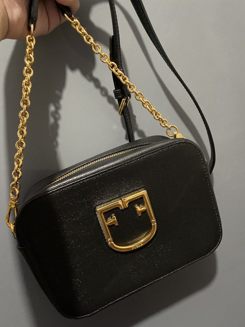 Furla Metropolis Mini Crossbody Bag (Category: Luxury Bags & Wallets) located in Batangas. Submitted by bagstolove3.0 (Listing ID 1431945403, Image 1). Description: - Authentic Furla Metropolis Mini crossbody bag - Color: Black - Gold-tone hardware - Chain strap - Zip closure - Furla logo detail - Interior includes Furla label and product tag - Made in Italy - Material: Genuine Leather.