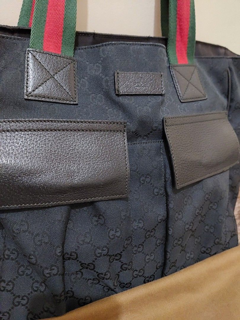 Gucci GG Canvas Tote Bag (Category: Luxury Bags & Wallets) located in Malabon City. Submitted by jullie_bag_shop (Listing ID 1431917168, Image 2). Description: - Authentic Gucci tote bag - Iconic GG canvas - Features green and red striped handles - Two front pockets - Includes dust bag.