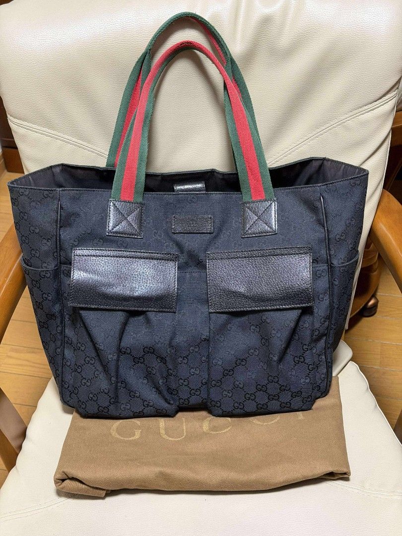 Gucci GG Canvas Tote Bag (Category: Luxury Bags & Wallets) located in Malabon City. Submitted by jullie_bag_shop (Listing ID 1431917168, Image 1). Description: - Authentic Gucci tote bag - Iconic GG canvas - Features green and red striped handles - Two front pockets - Includes dust bag.