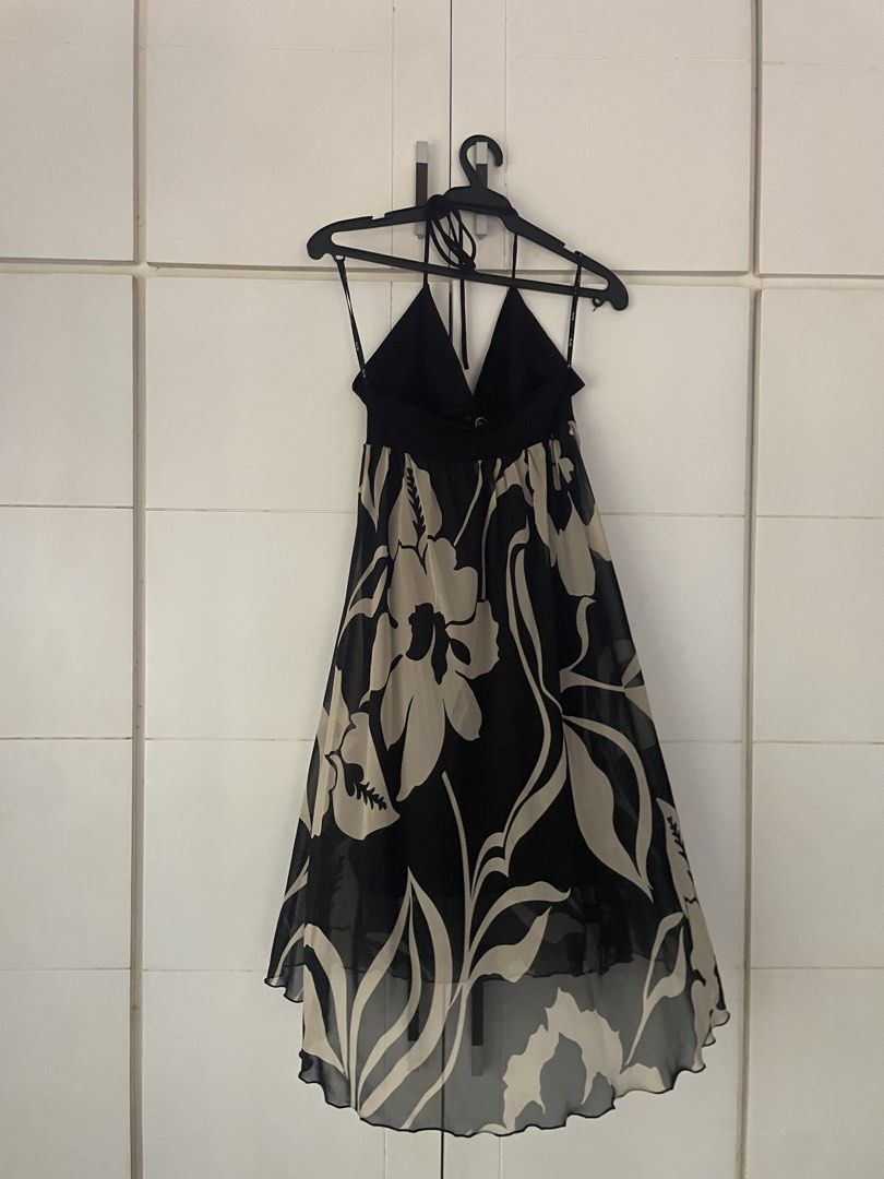 Halter Neck Floral Dress (Category: Dresses) located in Makati City. Submitted by slowflow (Listing ID 1431999207, Image 3). Description: - Halter neck design - Flowing skirt with black and beige floral pattern - V-neckline - Decorative eyelets at the waist - Lightweight, chiffon-like material - Asymmetrical hemline - used only once at a debut .