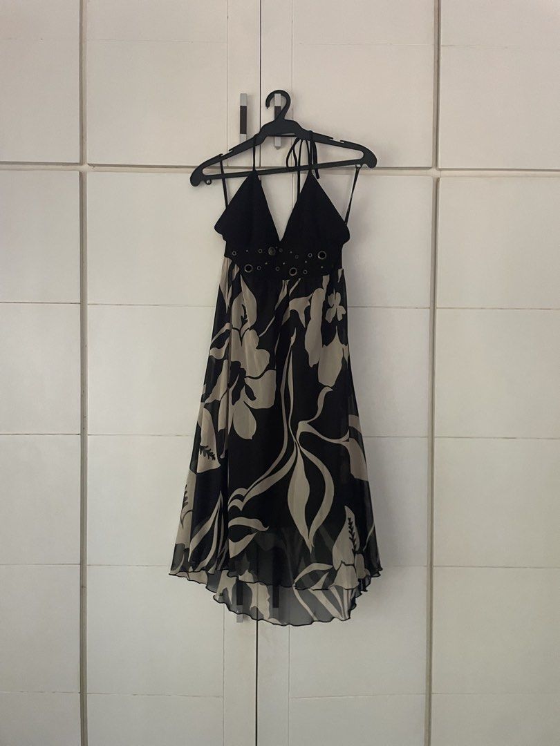Halter Neck Floral Dress (Category: Dresses) located in Makati City. Submitted by slowflow (Listing ID 1431999207, Image 1). Description: - Halter neck design - Flowing skirt with black and beige floral pattern - V-neckline - Decorative eyelets at the waist - Lightweight, chiffon-like material - Asymmetrical hemline - used only once at a debut .