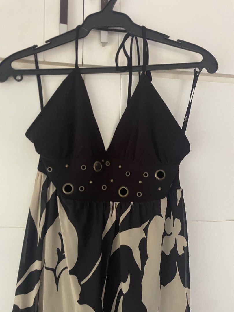 Halter Neck Floral Dress (Category: Dresses) located in Makati City. Submitted by slowflow (Listing ID 1431999207, Image 2). Description: - Halter neck design - Flowing skirt with black and beige floral pattern - V-neckline - Decorative eyelets at the waist - Lightweight, chiffon-like material - Asymmetrical hemline - used only once at a debut .