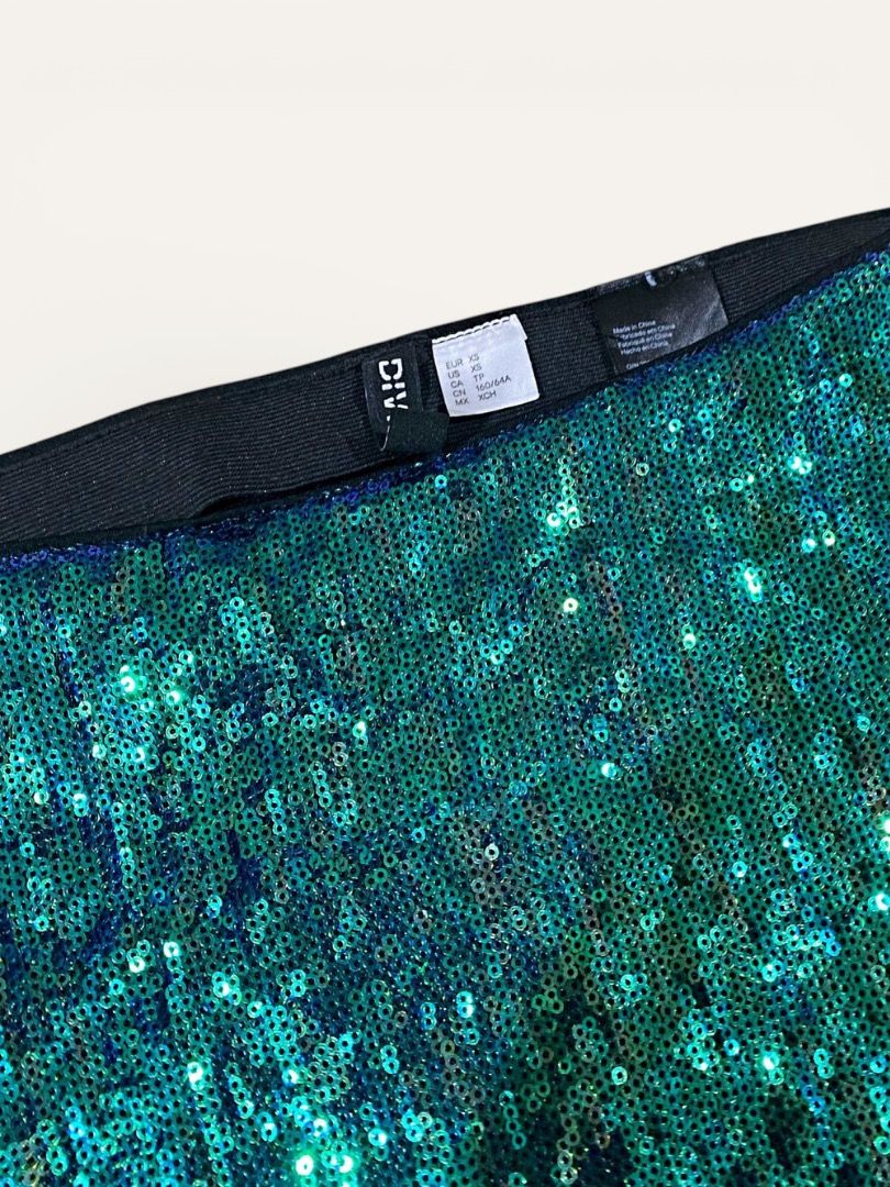 H&M Sequin Skirt and White Top Set (Category: Sets or Coordinates) located in Manila. Submitted by marsmarvelous (Listing ID 1431944008, Image 2). Description: ✨SALE✨ Php 249 only!! Used once only in SG for Taylor Swift concert! Perfect OOTD! - Green sequin skirt (size XS) with elastic waistband. - White top with sweetheart neckline and puff sleeves. (slightly discoloration on right off-shoulder - Medium on tag) - Ideal for special occasions or a
