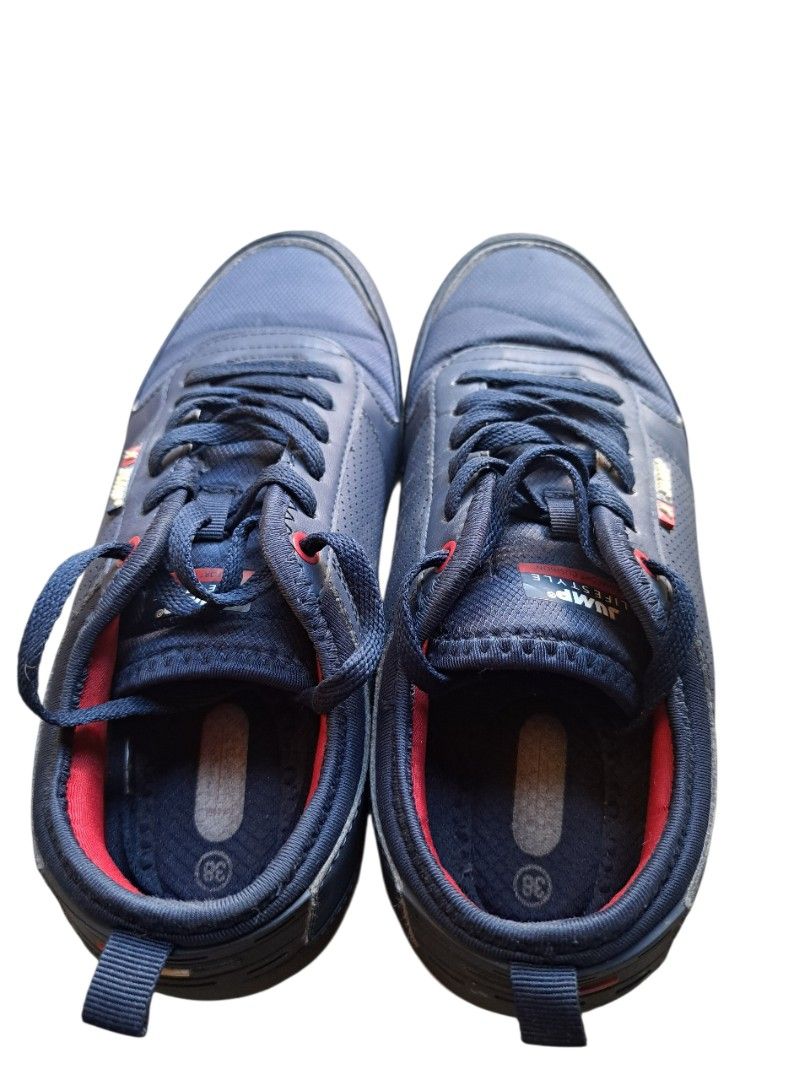 Jump Style Navy Blue Sneakers (Category: Sneakers) located in Caloocan City. Submitted by coolhearty_things (Listing ID 1431855458, Image 2). Description: Navy blue Jump Style sneakers. Features red accents on the inner lining and laces. The shoes have a cushioned sole with a white and red trim. The size is 38. The shoes have a lace-up closure and a padded tongue. The Jump Style logo is visible on the side of the shoe..