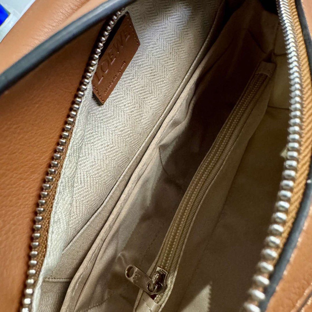 Loewe Puzzle Bag Small (Category: Luxury Bags & Wallets) located in Taguig. Submitted by ceegeedee (Listing ID 1431954664, Image 3). Description: - Loewe Puzzle Bag in brown - Top handle and detachable shoulder strap - Unique geometric design - Zipper closure - Multiple interior compartments - Includes dust bag - Perfect for everyday use.