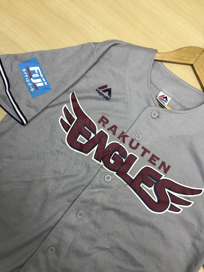 Majestic Rakuten Eagles Baseball Jersey (Category: Tshirts & Polo Shirts ) located in Manila. Submitted by hitsforfits (Listing ID 1431981822, Image 2). Description: • Rakuten Eagles Gray Baseball Jersey 📏 Size: M 📏 Dimes: 21 x 26.5 ₱ 299 - Gray Rakuten Eagles baseball jersey - Brand: Majestic - Features team name and logo on the front - Includes Fuji logo on the sleeve - Button-up closure - Short sleeves with white and navy trim - Visible tag 