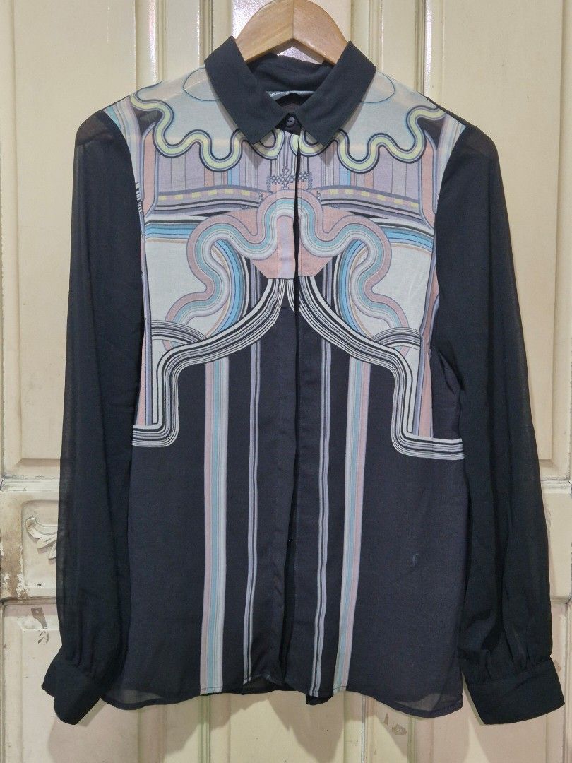 Miss Selfridge Sheer long-sleeved blouse (Category: Longsleeves) located in Quezon City. Submitted by redragtag (Listing ID 1431864478, Image 1). Description: Long-sleeved blouse featuring a unique geometric and curved print in pastel shades. A black sheer button-up shirt woth pointed collar, ling sleeves with buttoned cuffs. Lightweight fabric, concealed button placket design. Lightly used. No damage..