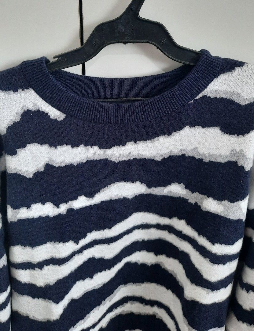 Navy Blue and White Striped Sweater (Category: Coats, Jackets and Outerwear) located in Cainta. Submitted by tinsbottomdrawer (Listing ID 1431889847, Image 2). Description: Sweater features a navy blue and white striped pattern. It has a crew neck and long sleeves. The cuffs and hem are solid navy blue. It is a versatile piece that can be worn for various occasions. Measurements: Shoulders Width: 55cm Sleeves: 57cm Waist Width: 57cm Length: 62cm.