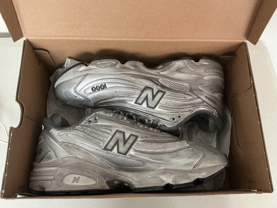 New Balance M1000G Silver Sneakers (Category: Sneakers) located in Quezon City. Submitted by mjcong (Listing ID 1431861323, Image 3). Description: - New Balance 1000 sneakers - Silver metallic finish - US size 10D - Includes original box - New Balance logo on side - Some wear on soles.