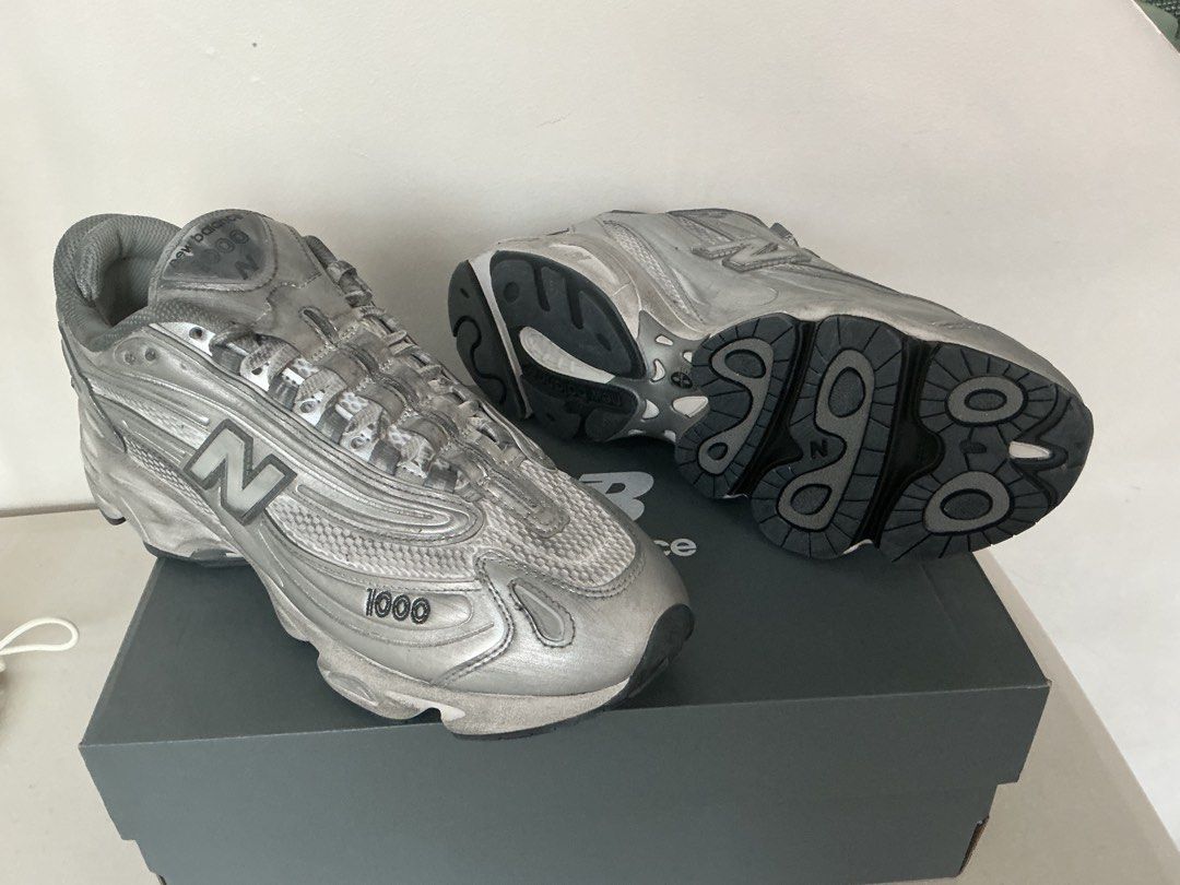 New Balance M1000G Silver Sneakers (Category: Sneakers) located in Quezon City. Submitted by mjcong (Listing ID 1431861323, Image 1). Description: - New Balance 1000 sneakers - Silver metallic finish - US size 10D - Includes original box - New Balance logo on side - Some wear on soles.