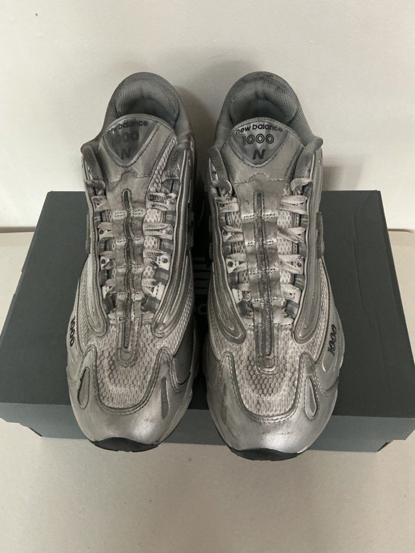 New Balance M1000G Silver Sneakers (Category: Sneakers) located in Quezon City. Submitted by mjcong (Listing ID 1431861323, Image 2). Description: - New Balance 1000 sneakers - Silver metallic finish - US size 10D - Includes original box - New Balance logo on side - Some wear on soles.