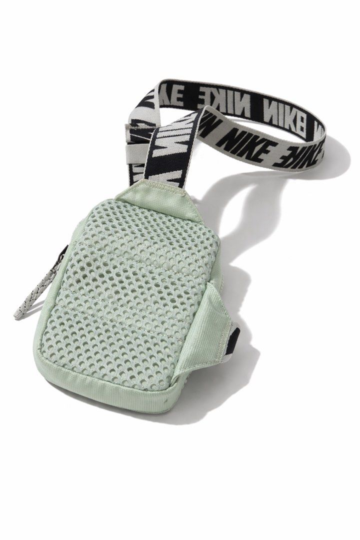 Nike Heritage Crossbody Bag (Category: Cross-body Bags) located in Antipolo. Submitted by cl026 (Listing ID 1431820836, Image 3). Description: - Nike Heritage Crossbody Bag - Mint green color - Full strap length 53" -SIZE: L6.5" x W4.5" - Repeating Nike logo on strap - Small, rectangular shape - Zippered main compartment - Smaller front pocket - Nike logo on front - Adjustable crossbody/shoulder strap.