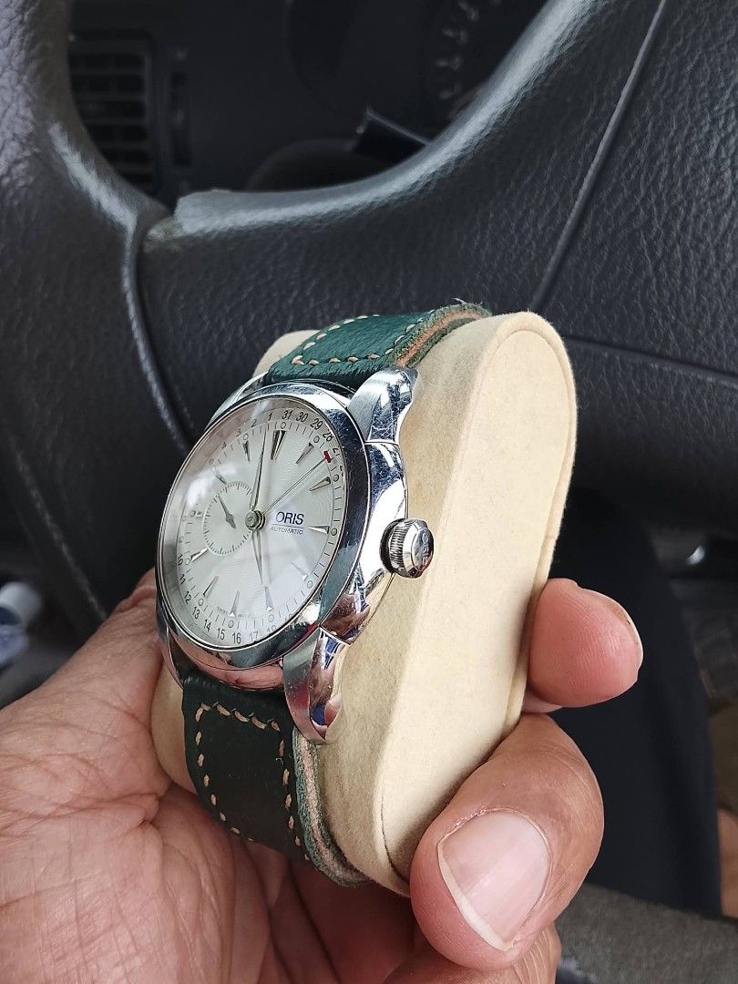 Oris Pointer Date Watch with Green Strap (Category: Watches) located in Gelang Patah. Submitted by quickcat.6c4f74 (Listing ID 1431969274, Image 3). Description: - Oris watch - Silver dial with pointer date function - Stainless steel case - Green leather strap - Visible crown - Features a subdial - Displays the Oris logo - Includes watch pillow SESUAI UNTUK koleksi tuan2 berminat boleh wasap saya 0142770264.