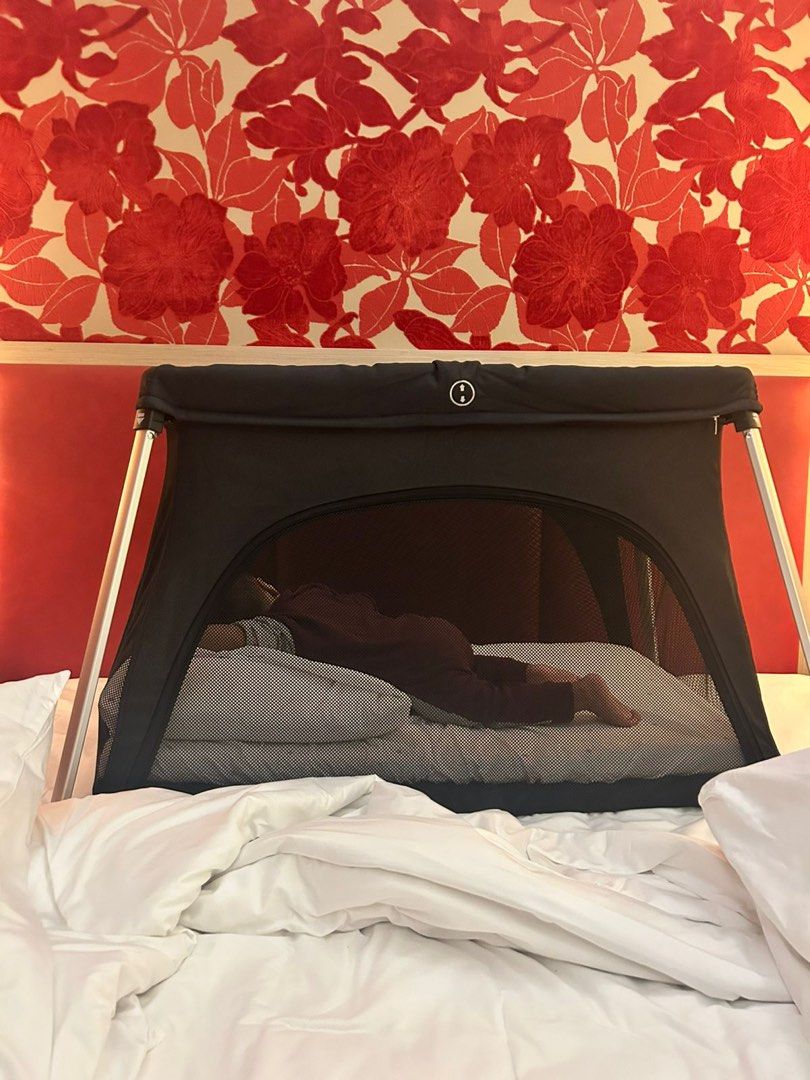 Portable Baby Bassinet (Category: Cots & Cribs) located in Makati City. Submitted by maried05 (Listing ID 1431943242, Image 1). Description: - Portable bassinet - Black mesh design for breathability and visibility - Sturdy frame - Comfortable sleeping surface - Easy to set up and fold down - Ideal for travel or home use - Provides a safe and cozy space for your baby Measurement: 36 x 22 inches Used just for 3 days during our SG trip *Baby in pict