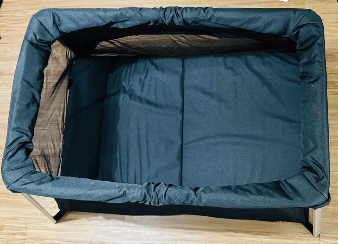 Portable Baby Bassinet (Category: Cots & Cribs) located in Makati City. Submitted by maried05 (Listing ID 1431943242, Image 3). Description: - Portable bassinet - Black mesh design for breathability and visibility - Sturdy frame - Comfortable sleeping surface - Easy to set up and fold down - Ideal for travel or home use - Provides a safe and cozy space for your baby Measurement: 36 x 22 inches Used just for 3 days during our SG trip *Baby in pict