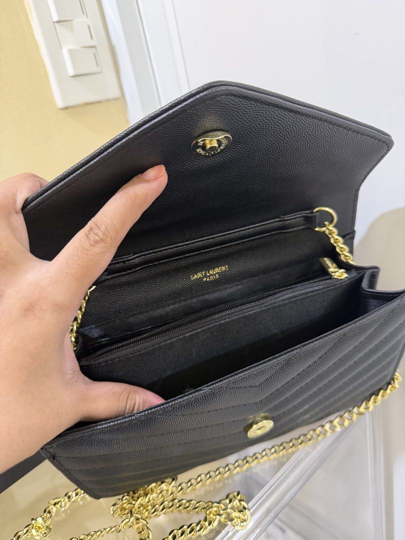 Saint Laurent YSL Chain Envelope Bag plus Free Wallet (Category: Luxury Bags & Wallets) located in San Jose del Monte. Submitted by bnewandpreloveditemstoloveee (Listing ID 1431805164, Image 3). Description: - Close to OG Saint Laurent YSL chain Bag and wallet - Classic black color - Elegant gold chain strap - Iconic YSL logo - Includes a matching card holder - Comes with box - Interior with multiple compartments for cards and cash - Stylish quil