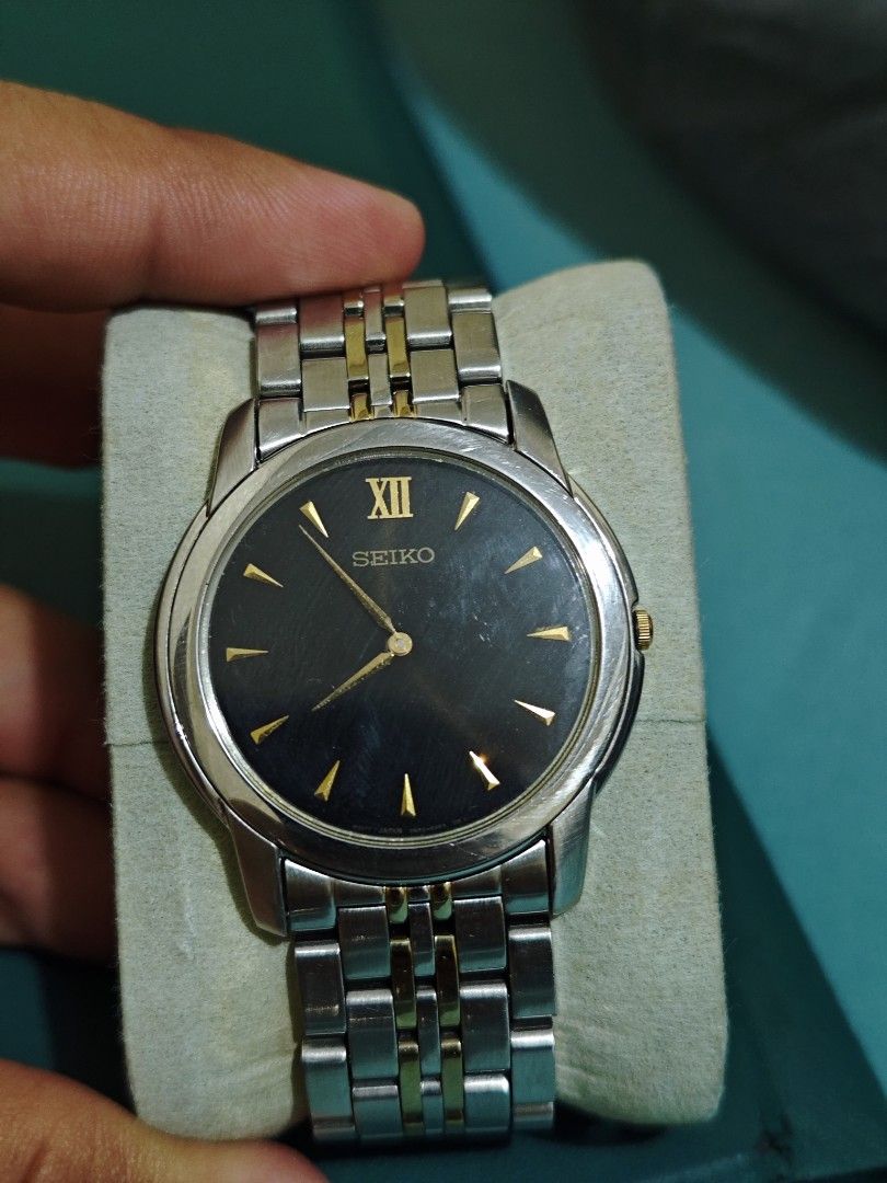 Seiko Stainless Steel Watch (Category: Men's Watches) located in Manila. Submitted by fdrakearon89191 (Listing ID 1431919372, Image 1). Description: - Seiko watch with a sleek black dial and elegant gold accents. - Features a durable stainless steel band with gold-tone links. - Protected by a scratch-resistant sapphire crystal. - Water-resistant design for everyday wear. - Powered by a reliable Japanese movement. - Model number: 7N00-Z480. -.