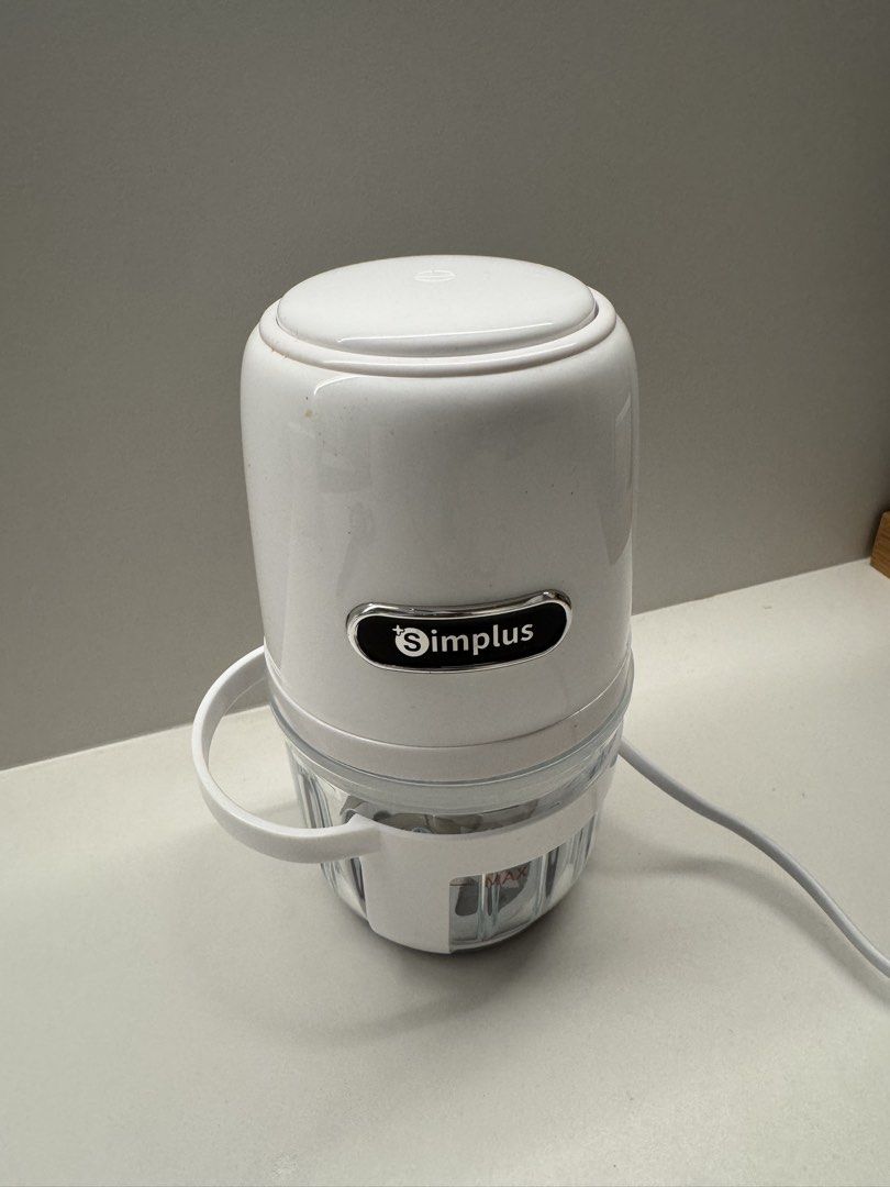 Simplus Mini Food Processor (Category: Juicers, Blenders & Grinders) located in Singapore. Submitted by tradesandmore (Listing ID 1431947825, Image 1). Description: - Perfect for chopping vegetables and fruits. - Easy to use and clean. - Clear container for monitoring contents. - Includes a handle for portability..