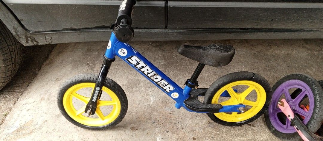 Strider Balance Bike - Blue (Category: Bicycles) located in Taytay. Submitted by misternedo (Listing ID 1431990199, Image 2). Description: - Strider balance bike - Blue frame with yellow wheels - Comfortable seat and handlebars - In good working condition - Ready for your child to use.