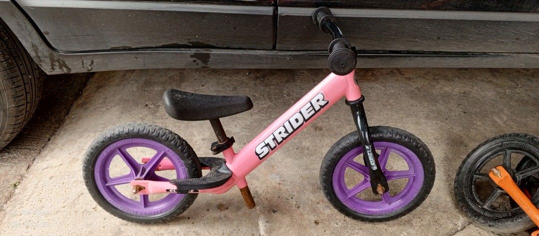 Strider Balance Bike - Pink (Category: Bicycles) located in Taytay. Submitted by misternedo (Listing ID 1431990157, Image 2). Description: - Pink Strider balance bike - Purple wheels - Black seat - Strider logo on frame - Ideal for toddlers.