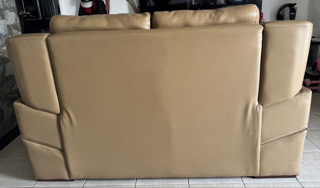 Tan Leather 2-Seater Sofa (with minor scratch) (Category: Sofas) located in Manila. Submitted by dondonc1026 (Listing ID 1431874817, Image 3). Description: Bought at SM Megamall Y2025 around 20k+ - Two-seater tan leather sofa - Features cushioned seats and armrests - Comfortable cushioned backrest - Modern design - Well-maintained condition - Ideal for living rooms and lounge areas.