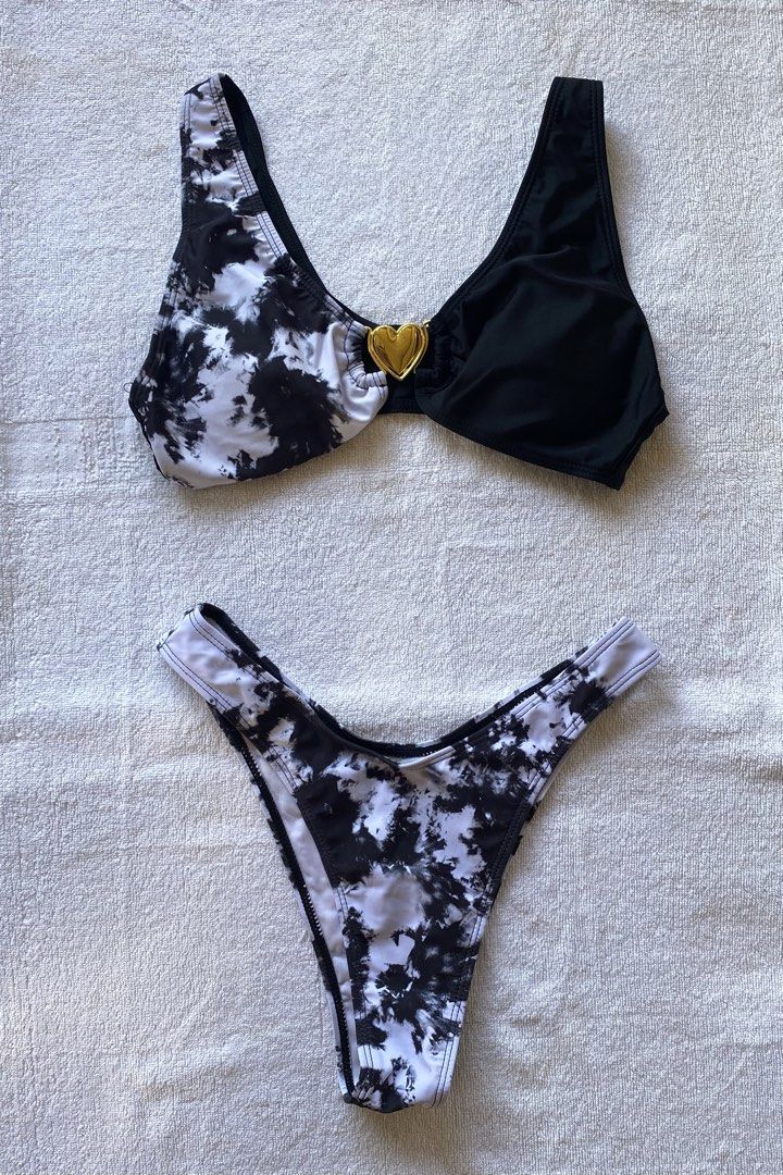 Tie-dye Bikini Set with Heart Detail (Category: Bikinis & Swimsuits) located in Batangas. Submitted by lovingmnl (Listing ID 1431924013, Image 1). Description: - Tie-dye bikini set - Top: Black and white design with gold heart accent - Bottoms: High-cut style - Ideal for beach or pool days.