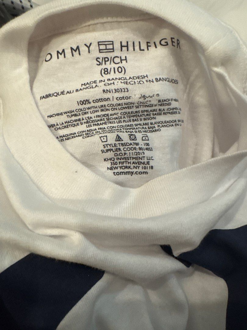 Tommy Hilfiger Graphic Tee (White, Size M) (Category: Blouses) located in Pasig City. Submitted by drea3600 (Listing ID 1431893298, Image 2). Description: Brand: Authentic Tommy Hilfiger Design: Large navy “H” with vertical red “HILFIGER” print Style: Classic crew neck T-shirt Size: Medium (M) Material: 100% Cotton – soft & breathable Origin: [Insert from tag if available, e.g., Made in Vietnam] Condition: Brand new (overrun / surplus) Fit: Men’s
