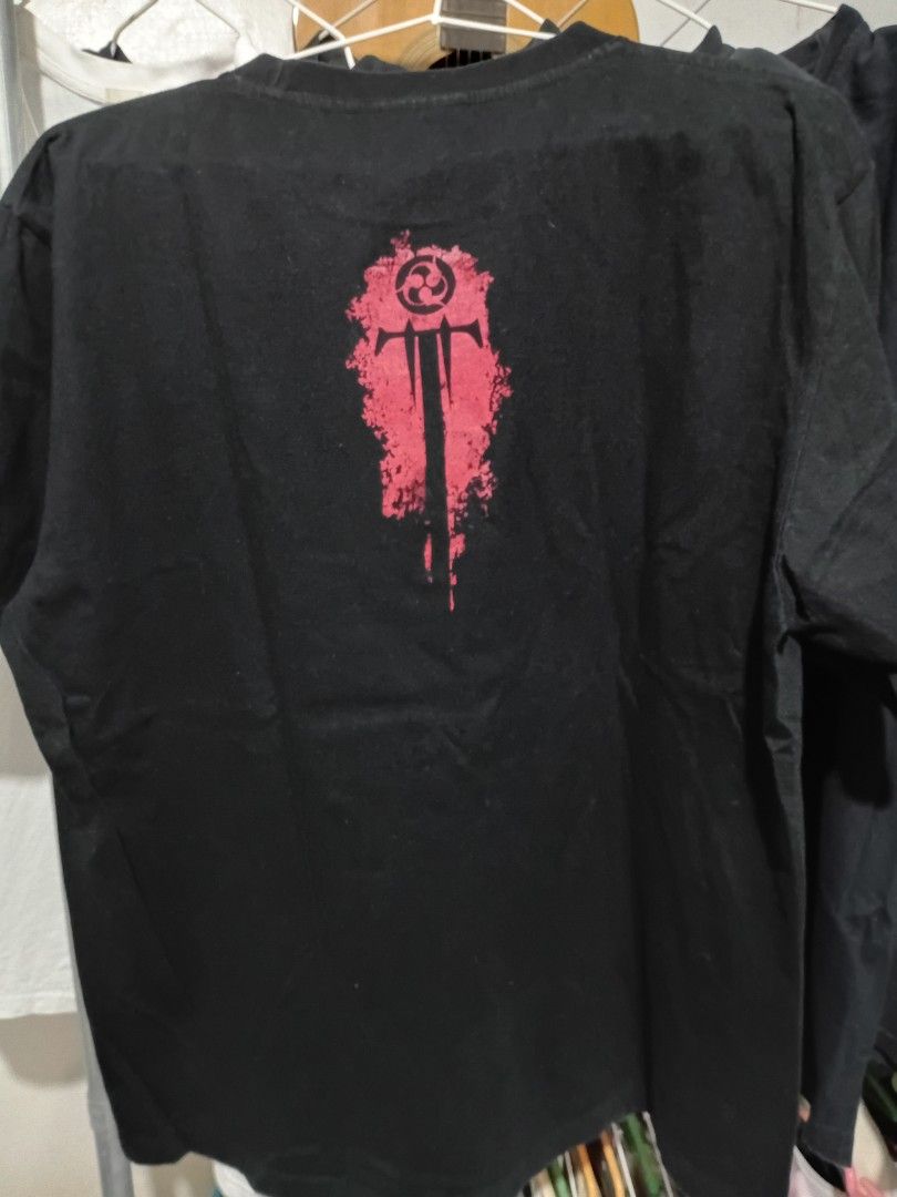 Trivium Band Graphic Tee (Category: Tshirts & Polo Shirts ) located in Quezon City. Submitted by reddcluttermnl (Listing ID 1431884807, Image 2). Description: - Trivium band t-shirt - Features a graphic on the front with the band's name and design - Includes a smaller Trivium logo on the back - Standard crew neck style.