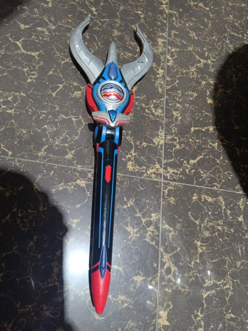 Ultraman DX Orb Slugger Lance (Category: Action & Battle Toys) located in Baliuag. Submitted by yuyus_corner20 (Listing ID 1431901039, Image 1). Description: - Ultraman DX Orb Slugger Lance - Color scheme: Black, blue, red, and silver. - Features a long handle and detailed head with horns. - Perfect for Ultraman collectors. - Working -on hand item - 2016 dated -with dents -good condition .