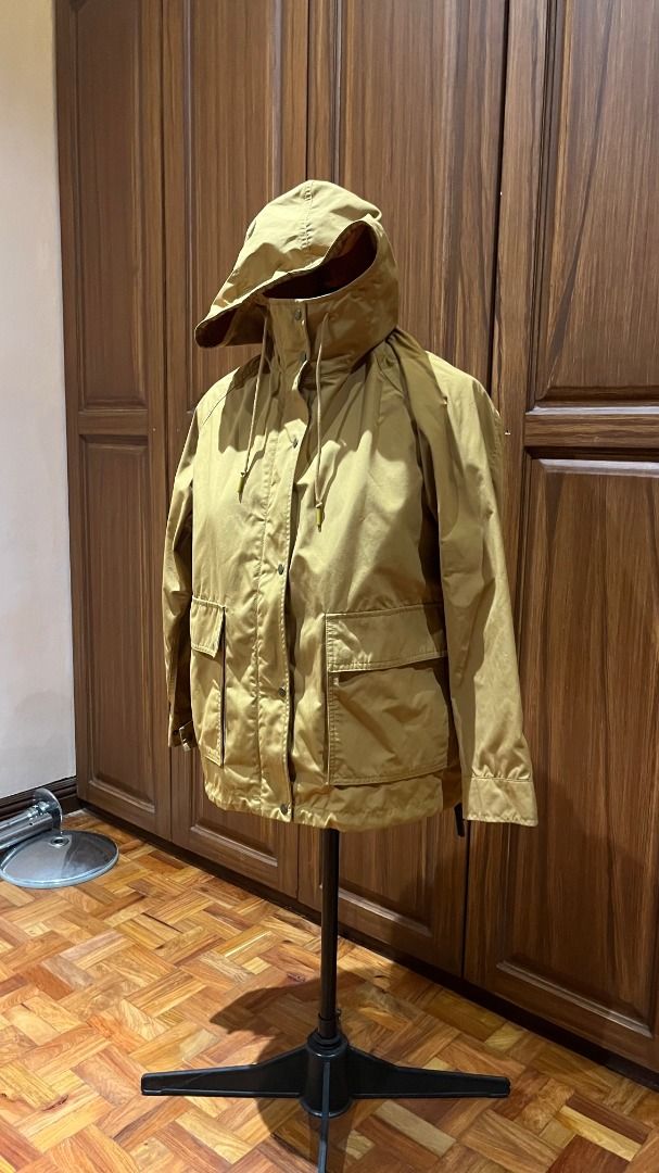 Uniqlo Parka / Raincoat - XL (Category: Coats, Jackets and Outerwear) located in Pasig City. Submitted by babypisces (Listing ID 1431928901, Image 1). Description: Uniqlo Hooded Raincoat Parka / Jacket in size XL Color hard to photograph. It is yellow-ish, looks like turmeric / a little khaki-like Water-repellent and windproof Zip and snap closure at front (4) Outer pockets Adjustable at waist / hips, hidden drawstring inside the hem Bought in Un