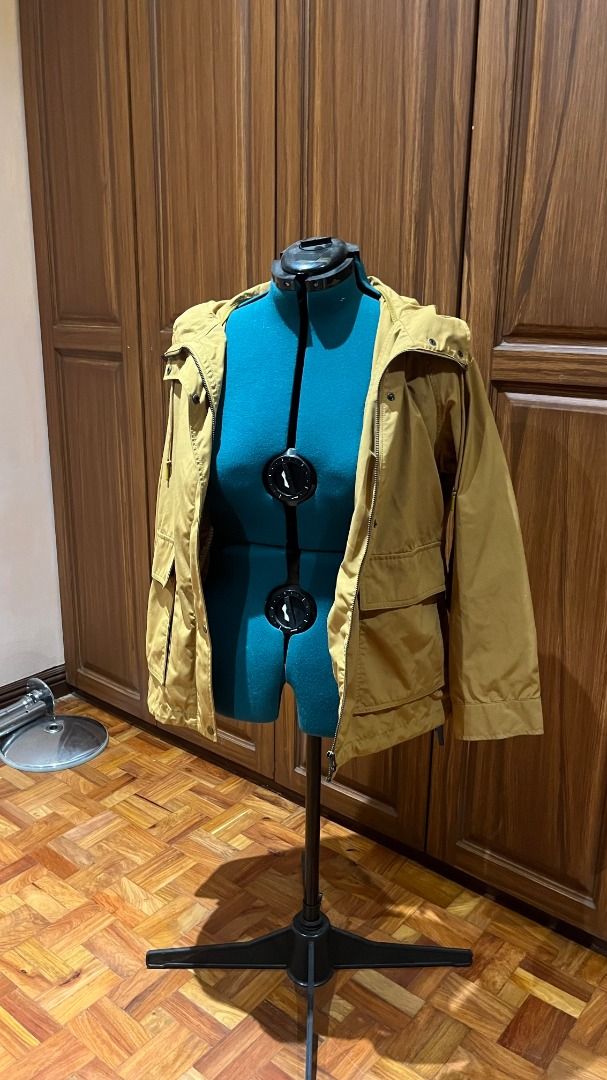 Uniqlo Parka / Raincoat - XL (Category: Coats, Jackets and Outerwear) located in Pasig City. Submitted by babypisces (Listing ID 1431928901, Image 3). Description: Uniqlo Hooded Raincoat Parka / Jacket in size XL Color hard to photograph. It is yellow-ish, looks like turmeric / a little khaki-like Water-repellent and windproof Zip and snap closure at front (4) Outer pockets Adjustable at waist / hips, hidden drawstring inside the hem Bought in Un