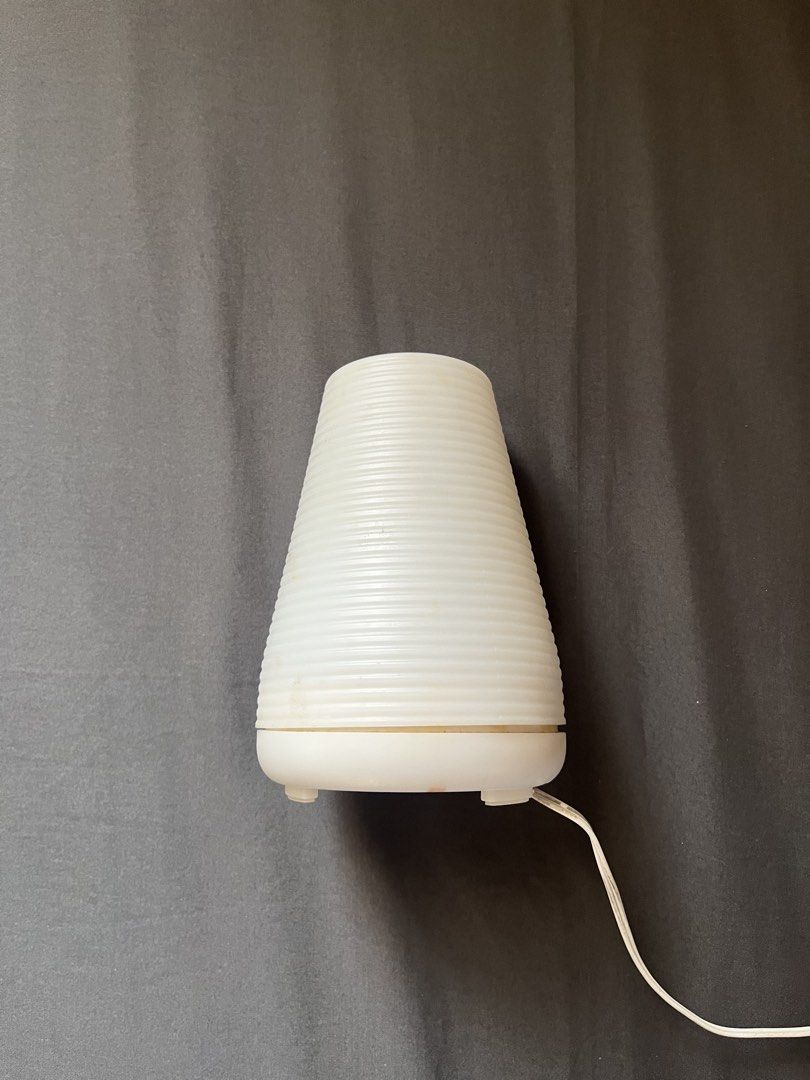 White Aroma Diffuser Cylinder Humidifier (Category: Air Purifiers & Dehumidifiers) located in Cavite. Submitted by mr.jbe (Listing ID 1431913586, Image 2). Description: Condition: 8.0/10.0 (Comes with free essential oils, With heavy signs of usage, no issues on functionality) - Free 2 essential oils - White aroma diffuser with a stylish ribbed design. - Includes a power adapter for immediate use. - Features convenient light and mist control butto