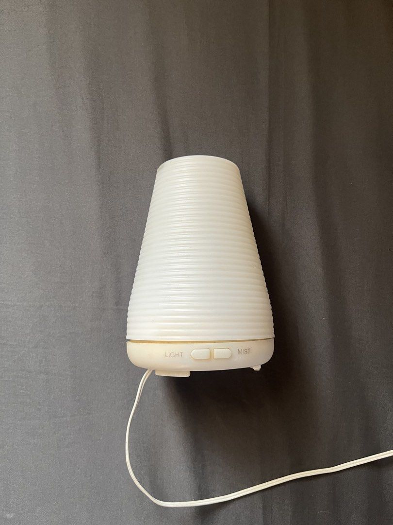 White Aroma Diffuser Cylinder Humidifier (Category: Air Purifiers & Dehumidifiers) located in Cavite. Submitted by mr.jbe (Listing ID 1431913586, Image 1). Description: Condition: 8.0/10.0 (Comes with free essential oils, With heavy signs of usage, no issues on functionality) - Free 2 essential oils - White aroma diffuser with a stylish ribbed design. - Includes a power adapter for immediate use. - Features convenient light and mist control butto