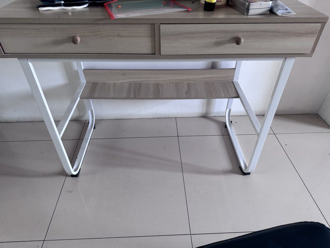 STUDY TABLE Desk with Drawers (Category: Tables & Sets) located in Manila. Submitted by decluterthings888 (Listing ID 1431821995, Image 2). Description: - ❌❌DECLUTTER FOR GARAGE SALE ✅ PUCKUP C/O BUYER ✅SELLING VERY LOW ✅EXPECT SIGN OF USAGE SELLING LOW DONT EXPECT BRAND NEW Light wood finish desk - White metal frame - Two drawers for storage - Lower shelf for additional storage - Round wooden knobs - Sturdy and functional design - Ideal for home