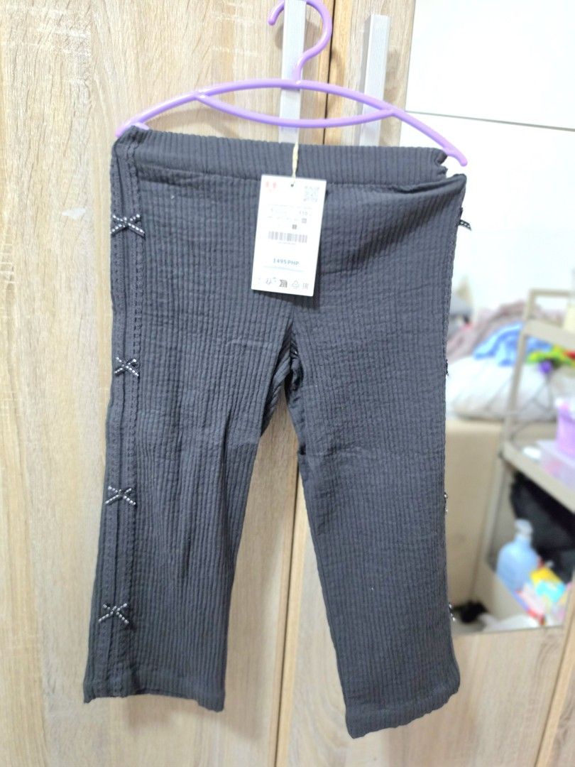 ZARA Kids Top and Pants Set (Category: Babies & Kids Fashion) located in Angono. Submitted by declothering.ph (Listing ID 1431810984, Image 2). Description: - Ribbed fabric set - Long-sleeved top with ruffled hem - Bow details on top and pants - Button-up front on top - Matching pants included - Stylish and comfortable.