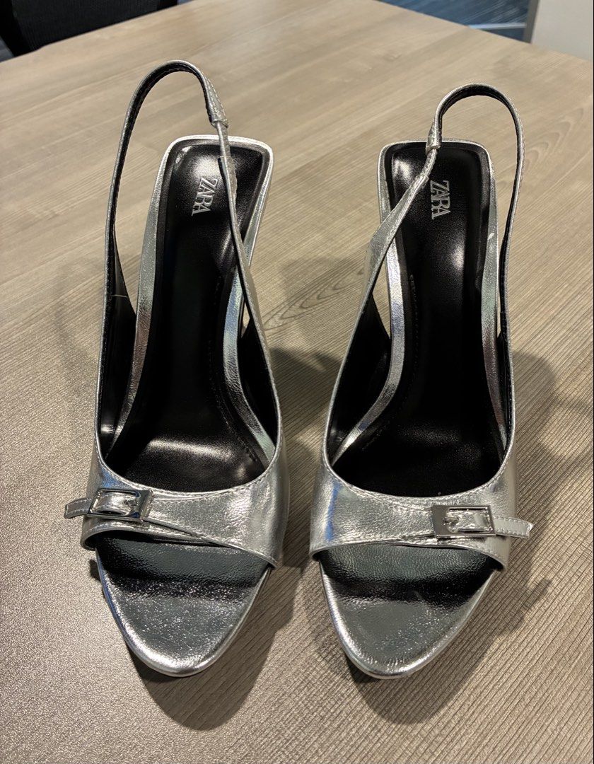 Zara Metallic High-Heel Slingback Sandals (Category: Heels) located in Las Pinas. Submitted by masterjac (Listing ID 1431822641, Image 3). Description: - Zara silver metallic slingback sandals - Buckle detail on front strap - Black stiletto heel - Slingback strap for support - Black soles - Unworn.