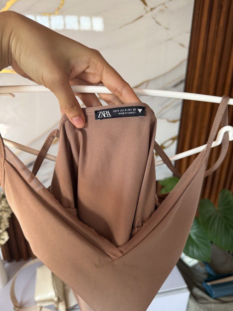 Zara V-neck Cami Top (Category: Sleeveless) located in Marikina City. Submitted by declutter_keni24 (Listing ID 1431802857, Image 3). Description: - Zara cami top - Size: S - Features a V-neck and spaghetti straps - Color: Neutral brown - Made in Turkey - Perfect for dressing up or down.