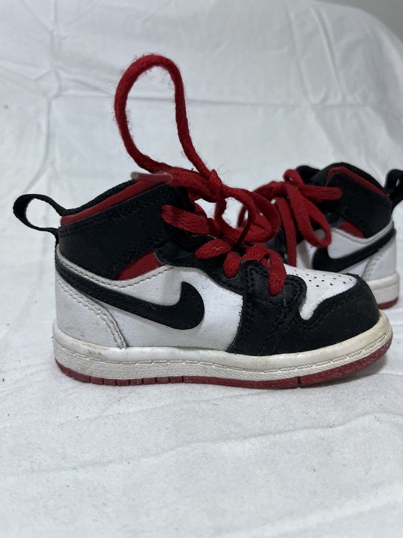 Air Jordan 1 Mid Infant Sneakers (Category: Babies & Kids Fashion) located in San Fernando. Submitted by isayet (Listing ID 1432166448, Image 2). Description: - Infant Air Jordan 1 Mid sneakers - Color: Black, white, and red - Features Nike swoosh - Red laces - Pull tab at the back - White and red soles - Designed for toddlers.