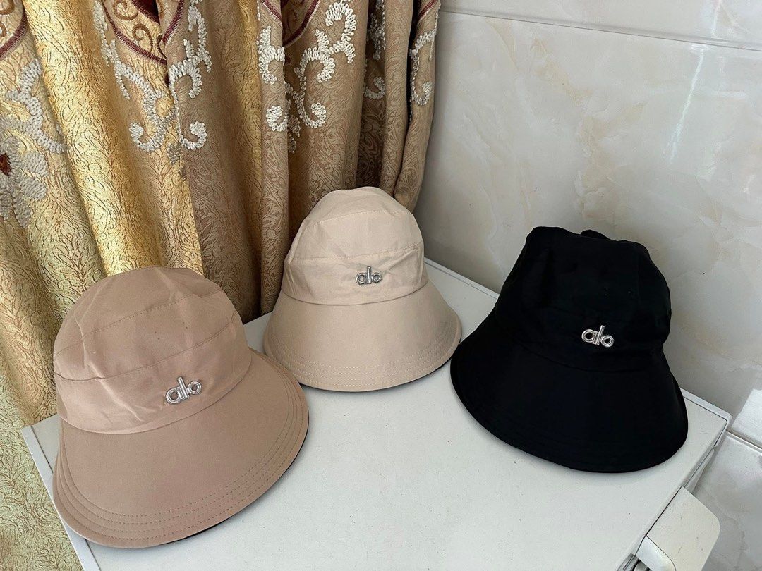 Alo & Lululemon Bucket Hats (Category: Hats & Beanies) located in Valenzuela. Submitted by shopwithmika (Listing ID 1432152577, Image 1). Description: - Brand: Alo and Lululemon - Colors: Beige, Black, Tan - Features: Logo details, Adjustable straps - Benefits: Sun protection, Fashionable accessory.