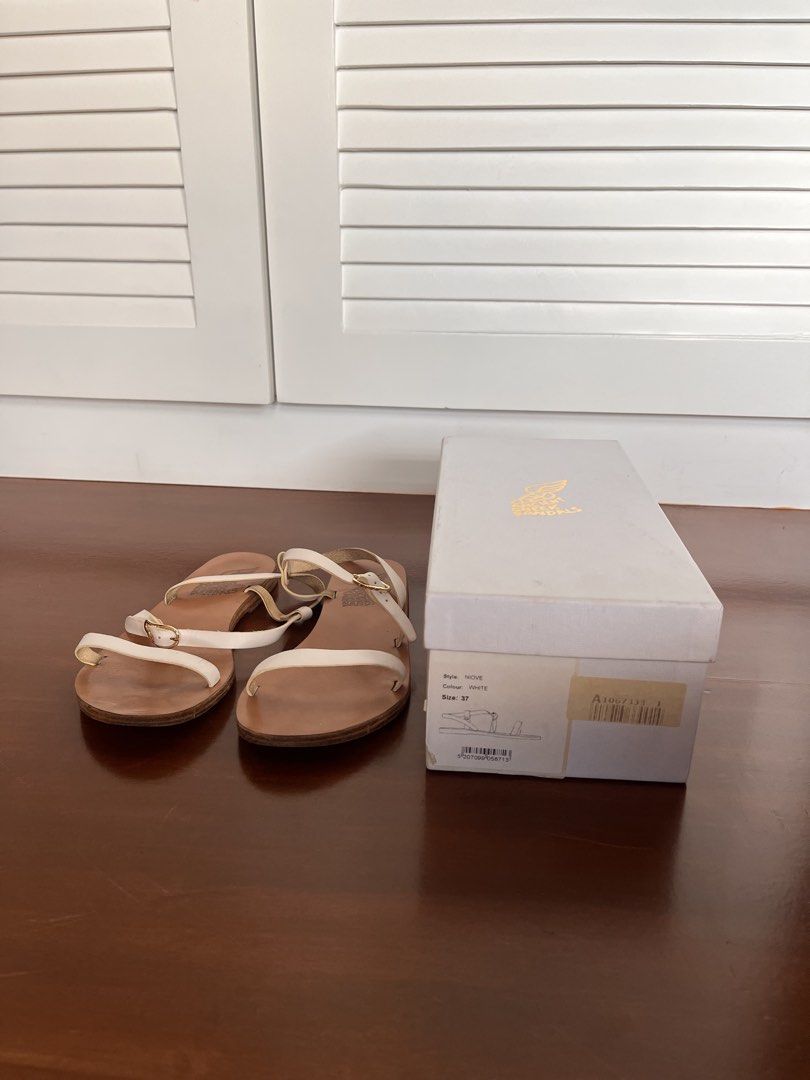 Ancient Greek Sandals - Niki White (Category: Flats & Sandals) located in Paranaque City. Submitted by threadup (Listing ID 1432032162, Image 1). Description: - Authentic Ancient Greek Sandals Niki - White color - Size 37 - Features adjustable white leather straps - Brown leather sole - Comes with original box - Classic, minimalist design - Perfect for everyday wear.