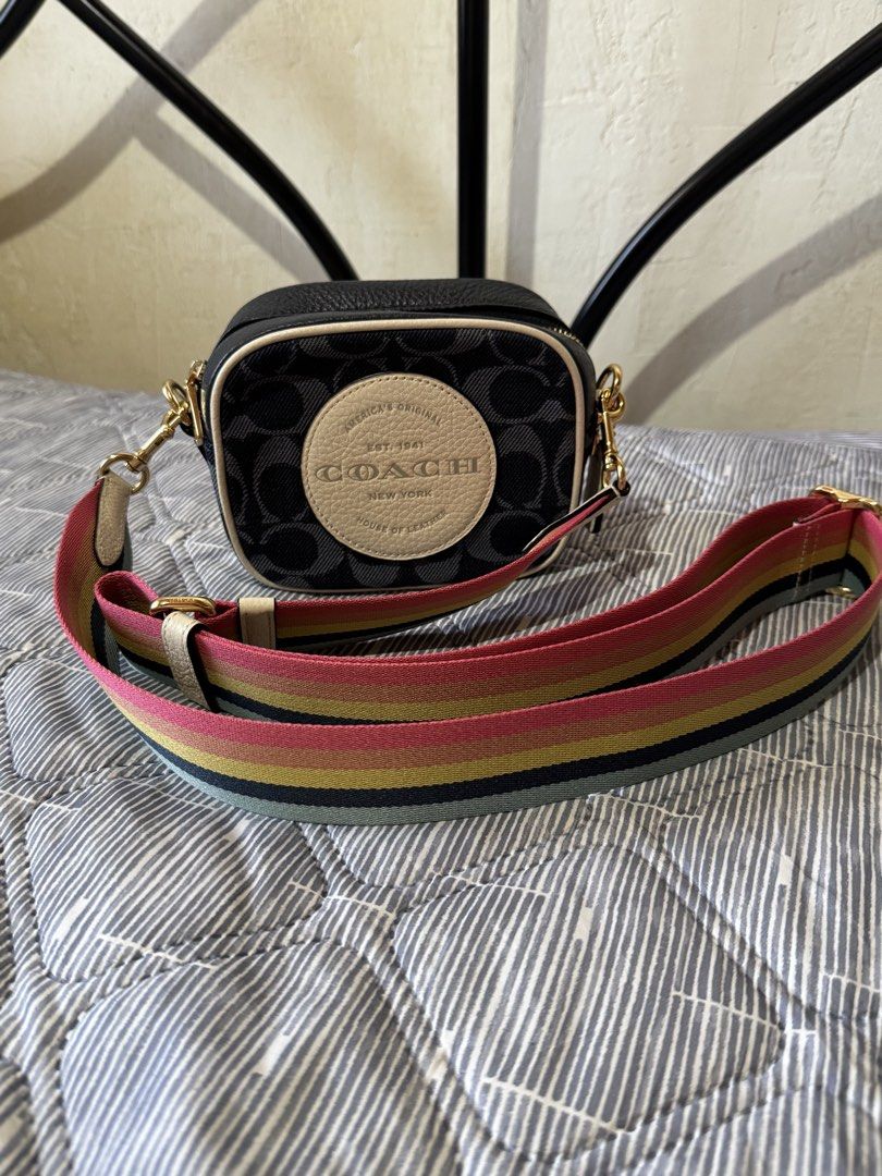 coach mini dempsey camera bag (Category: Luxury Bags & Wallets) located in Danao, Cebu. Submitted by jojie.1983 (Listing ID 1432054316, Image 1). Description: - Authentic Coach crossbody bag - Signature Coach pattern - Rainbow strap - Gold-tone hardware - Zip closure - Circular logo detail - Interior: Black - Includes small tag - Made in Cambodia.