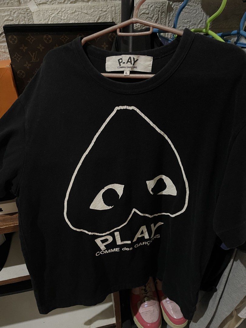 Comme des Garcons Play T-shirt - Black (Category: Shirts) located in San Fernando. Submitted by unc_thrifts (Listing ID 1432175722, Image 1). Description: - Black Comme des Garcons Play T-shirt - Iconic heart logo on the front - Crew neck and short sleeves - Size: L - Made in Japan - Material: 100% cotton.