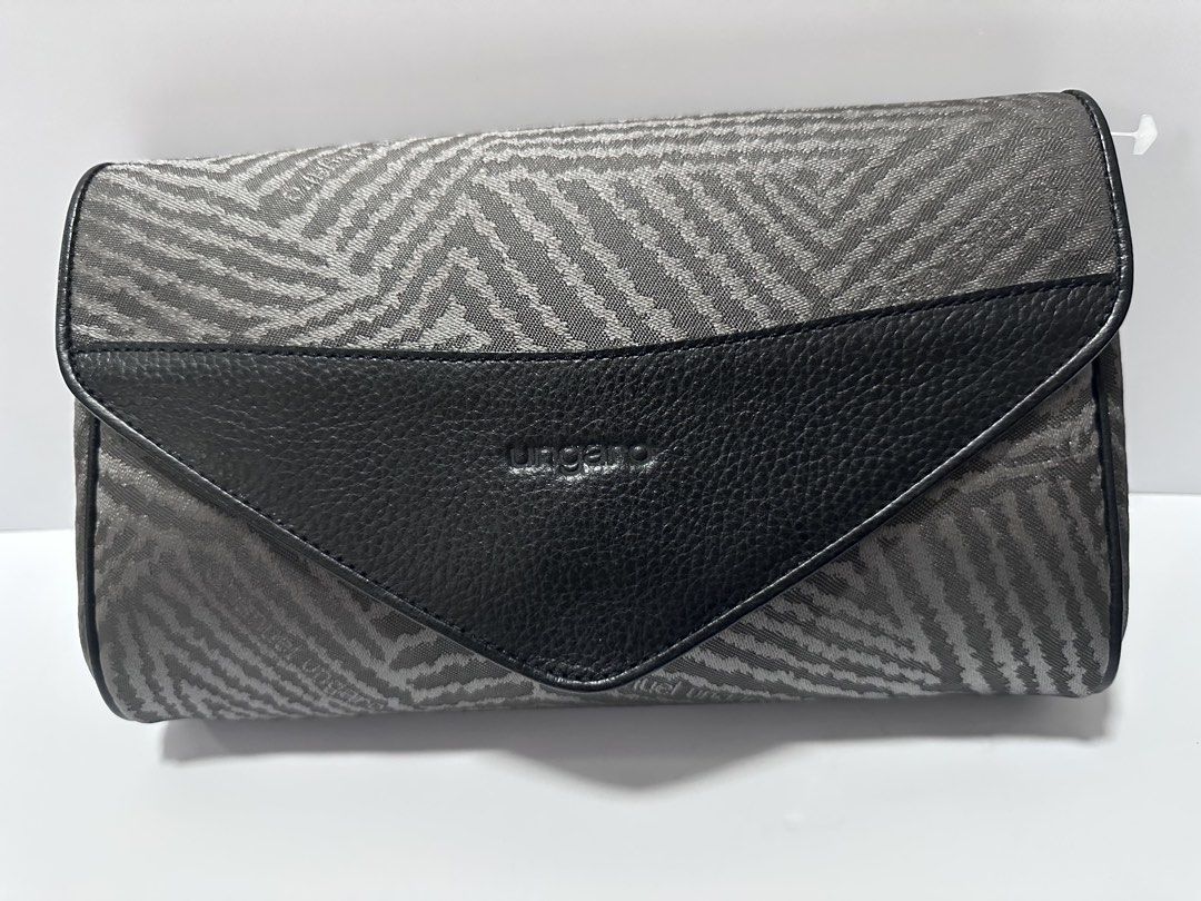 Emanuel Ungaro Paris Clutch (Category: Luxury Bags & Wallets) located in San Juan City. Submitted by vrgyl (Listing ID 1432022813, Image 1). Description: - Emanuel Ungaro Paris clutch - Unique patterned fabric with black leather accents - Magnetic closure - Dimensions: Approximately 10" (L) x 6" (H) x 2" (W) - Spacious interior - Features brand label inside.