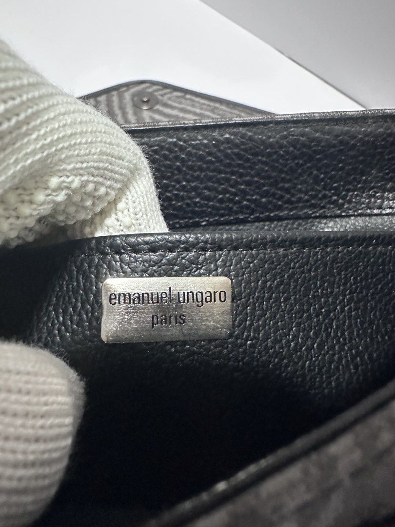 Emanuel Ungaro Paris Clutch (Category: Luxury Bags & Wallets) located in San Juan City. Submitted by vrgyl (Listing ID 1432022813, Image 3). Description: - Emanuel Ungaro Paris clutch - Unique patterned fabric with black leather accents - Magnetic closure - Dimensions: Approximately 10" (L) x 6" (H) x 2" (W) - Spacious interior - Features brand label inside.