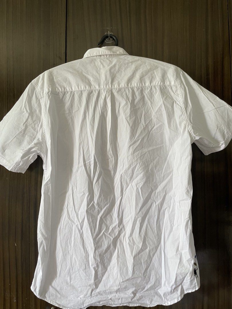 Embroidered White Short Sleeve Shirt (Category: Shirts) located in Antipolo. Submitted by misalrad (Listing ID 1432035915, Image 3). Description: - White short sleeve shirt - Embroidered chest pocket with leaves, flowers, and figures - Button-down front - Classic collar - Perfect for casual wear.