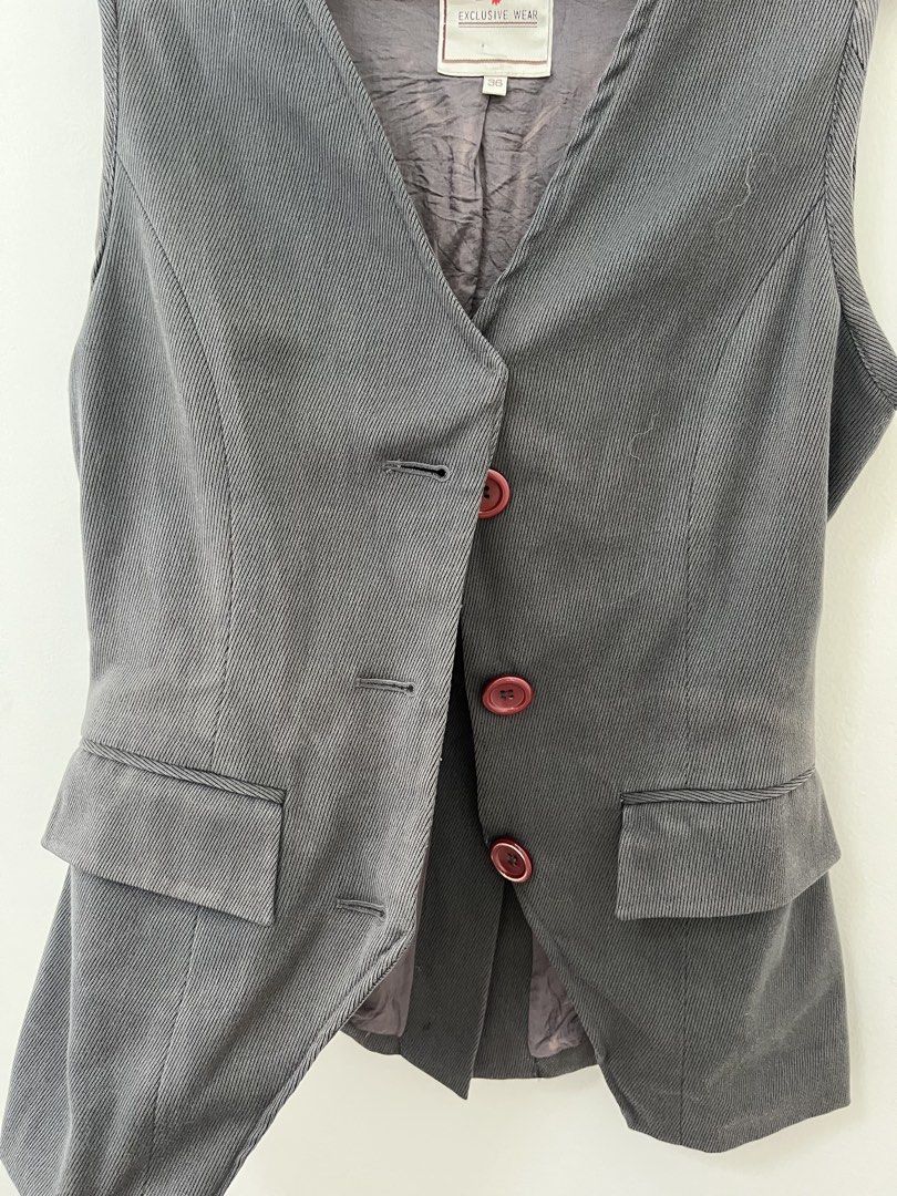 Exclusive Wear Gray Vest (Category: Vests) located in Cavite. Submitted by letsgosab (Listing ID 1432195767, Image 2). Description: - Exclusive Wear gray vest - V-neck design - Features front pockets - Button closure with contrasting color buttons - Tailored fit - Unique design - Includes lining - Back of vest has a small belt detail.