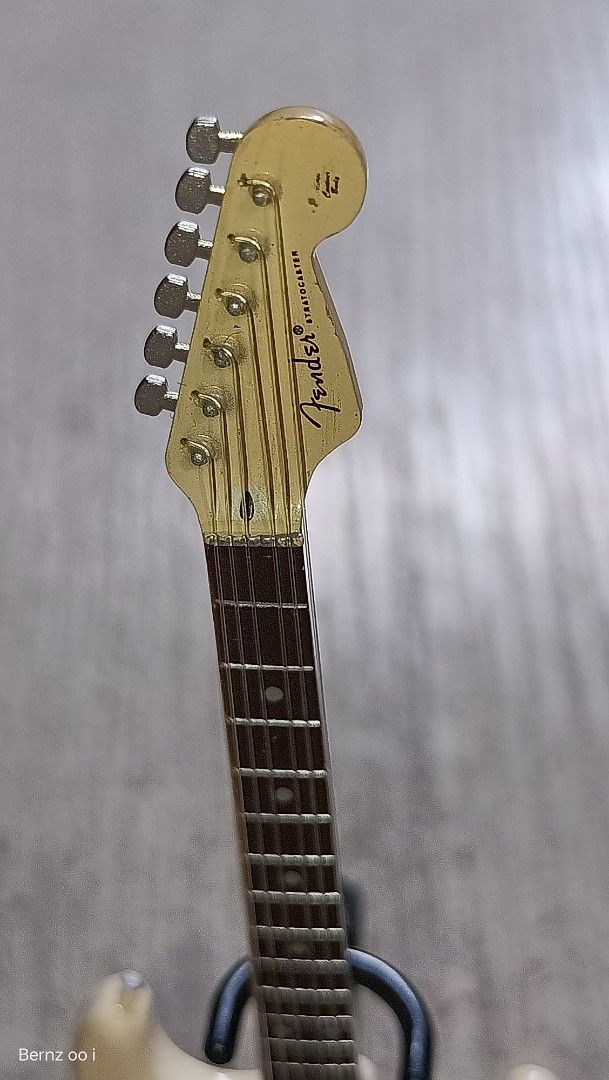 Fender Stratocaster Miniature Guitar (Category: Musical Instruments) located in Quezon City. Submitted by Bernz (Listing ID 1432043162, Image 3). Description: - Miniature Fender Stratocaster guitar - Cream-colored body - Dark fretboard - Silver tuning pegs - Includes a black stand - Features the Fender logo on the headstock - Perfect for collectors or as a unique decoration.