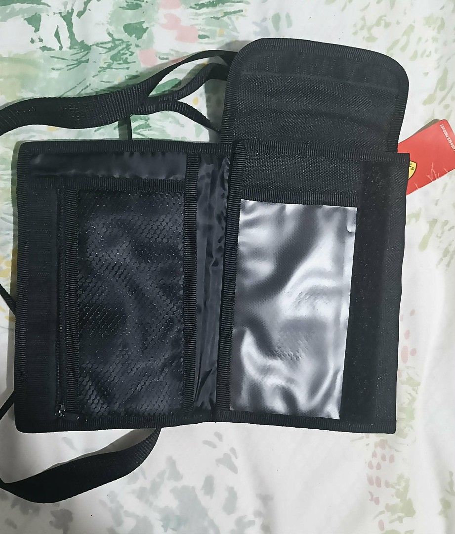 Ferrari Crossbody Bag (Category: Luxury Bags & Wallets) located in Angeles City. Submitted by victoria_l. (Listing ID 1432067247, Image 3). Description: Black Ferrari crossbody bag with a detachable strap. Features the Ferrari logo on the front. The interior includes multiple compartments, including a zippered pocket, a clear pocket, and several card slots. Comes with a tag..